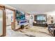 Bright living room with fireplace and kitchen access at 6039 W Fair Dr, Littleton, CO 80123