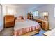 Cozy bedroom featuring vintage wooden furniture and soft bedding at 6039 W Fair Dr, Littleton, CO 80123
