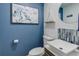 Modern powder room with updated vanity and stylish blue walls at 6039 W Fair Dr, Littleton, CO 80123