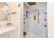 Spa-like shower with a rainfall showerhead and gold accents at 6039 W Fair Dr, Littleton, CO 80123