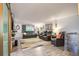 Living room with leather recliners, a large TV, and a stone accent wall at 6039 W Fair Dr, Littleton, CO 80123