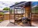 Covered deck with seating area, fire pit, and sliding glass panels at 6039 W Fair Dr, Littleton, CO 80123