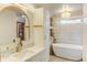 Luxurious bathroom with a freestanding tub and gold fixtures at 6039 W Fair Dr, Littleton, CO 80123