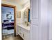 Modern bathroom with a white vanity and a view of the bedroom at 6039 W Fair Dr, Littleton, CO 80123