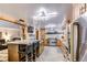 Open kitchen with an island and breakfast bar at 6039 W Fair Dr, Littleton, CO 80123