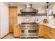 Gourmet kitchen with a professional range and custom cabinetry at 6039 W Fair Dr, Littleton, CO 80123
