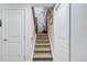 Well-lit carpeted staircase leading to the upper level at 6039 W Fair Dr, Littleton, CO 80123