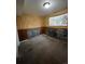 Unfinished basement room with wood paneling and window at 16032 E Floyd Ave, Aurora, CO 80013