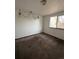 Simple bedroom with carpeted floor, window, and light fixture at 16032 E Floyd Ave, Aurora, CO 80013
