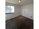 Simple bedroom with carpeted floor, window, and light fixture at 16032 E Floyd Ave, Aurora, CO 80013