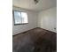 Simple bedroom with carpeted floor, window, and light fixture at 16032 E Floyd Ave, Aurora, CO 80013