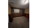 Cozy bedroom with wood paneling and window at 16032 E Floyd Ave, Aurora, CO 80013