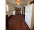 Dining area with hardwood floors, kitchen view, and loft access at 16032 E Floyd Ave, Aurora, CO 80013