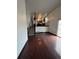 Open concept living room with hardwood floors and kitchen view at 16032 E Floyd Ave, Aurora, CO 80013
