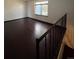 Large living room with dark hardwood floors and loft view at 16032 E Floyd Ave, Aurora, CO 80013
