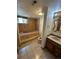 Basement bathroom with soaking tub and shower at 2318 S Rifle St, Aurora, CO 80013