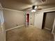 Tan bedroom with carpet, ceiling fan, and access to another room at 2318 S Rifle St, Aurora, CO 80013