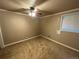 Tan bedroom with carpet, ceiling fan and double door closet at 2318 S Rifle St, Aurora, CO 80013