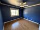 Blue bedroom with hardwood floors and a ceiling fan at 2318 S Rifle St, Aurora, CO 80013