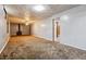 Large basement with neutral walls and carpet at 14830 Robins Dr, Denver, CO 80239