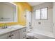 Clean bathroom with yellow walls and white vanity at 14830 Robins Dr, Denver, CO 80239