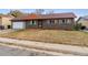 Ranch style home with a two-car garage and neat lawn at 14830 Robins Dr, Denver, CO 80239