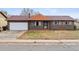 Brick ranch home with attached garage and mature landscaping at 14830 Robins Dr, Denver, CO 80239