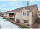 Townhome's back exterior, showcasing a deck and snowy yard at 1755 Moorwood Pt, Monument, CO 80132