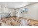 Living area with hardwood floors, staircase, and window at 3520 W Dill Rd, Englewood, CO 80110