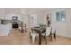 Kitchen dining area with hardwood floors and a modern dining table at 34 University Dr, Longmont, CO 80503