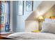 Bedroom detail showing a wood nightstand and a window with curtains at 654 County Road 672, Breckenridge, CO 80424
