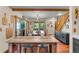 Rustic dining room featuring a large wooden table and access to kitchen at 654 County Road 672, Breckenridge, CO 80424