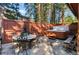 Relax in the private hot tub, surrounded by a wooden fence and stone patio at 654 County Road 672, Breckenridge, CO 80424