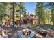 Rustic mountain home with a fire pit, surrounded by lush trees at 654 County Road 672, Breckenridge, CO 80424