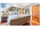 Main bedroom with a wooden sleigh bed, hardwood floors, and a mirrored closet at 654 County Road 672, Breckenridge, CO 80424