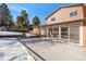 Concrete patio area in the backyard with snowy landscaping at 824 W Geddes Cir, Littleton, CO 80120