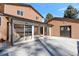 Home features a spacious backyard patio, attached to a large sunroom, and detached garage at 824 W Geddes Cir, Littleton, CO 80120