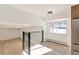Open loft area with hardwood floors and a window at 824 W Geddes Cir, Littleton, CO 80120