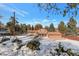 View of the home's back elevation, showcasing its patio and landscaping at 824 W Geddes Cir, Littleton, CO 80120