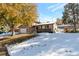 Landscaped yard with mature trees and light snow cover at 824 W Geddes Cir, Littleton, CO 80120