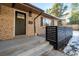 Dark brown front door with modern black railing at 824 W Geddes Cir, Littleton, CO 80120