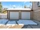 Two-car garage with white doors and brick exterior at 824 W Geddes Cir, Littleton, CO 80120