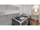 Bright laundry room with washer, dryer, and ample shelving at 824 W Geddes Cir, Littleton, CO 80120