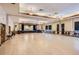 Large community room with hardwood floors and a stage at 3184 S Heather Gardens Way # 302, Aurora, CO 80014
