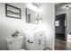 Bathroom features a white vanity, modern fixtures, and a small plant at 10439 King Cir, Westminster, CO 80031