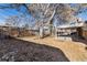 Spacious backyard with covered patio, mature trees, and shed at 6851 S Franklin St, Centennial, CO 80122