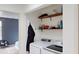 Laundry room with washer, dryer, and additional shelving at 762 Mockingbird Ln, Brighton, CO 80601