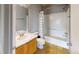 Bathroom with shower/tub combo, wood vanity, and tile floor at 762 Mockingbird Ln, Brighton, CO 80601
