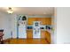 View of kitchen with wood cabinets, appliances, and laminate flooring at 762 Mockingbird Ln, Brighton, CO 80601