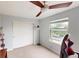Bedroom with window, ceiling fan, and a large closet at 762 Mockingbird Ln, Brighton, CO 80601